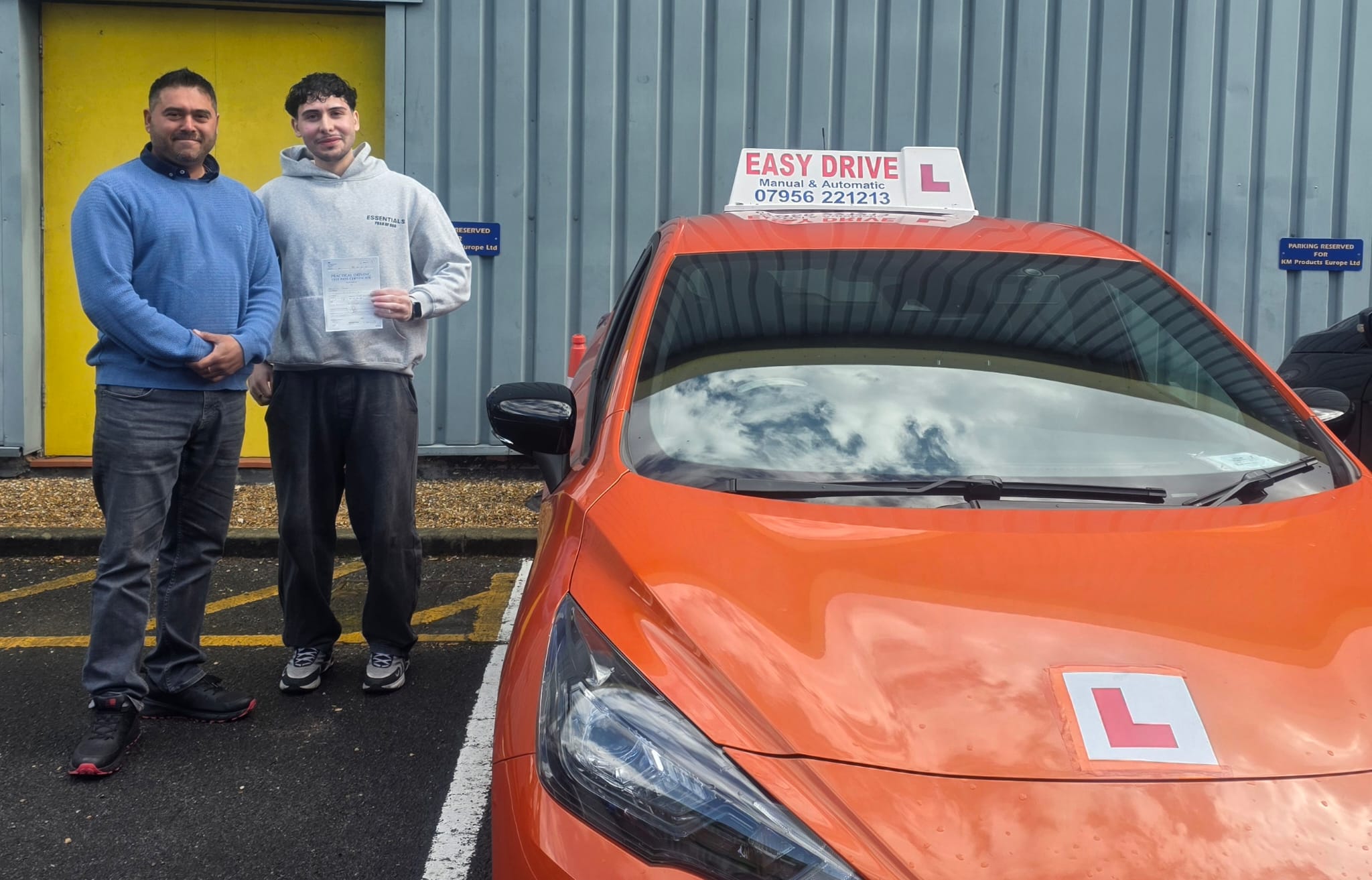 Instructor and student celebrating driving test pass with Easy Drive